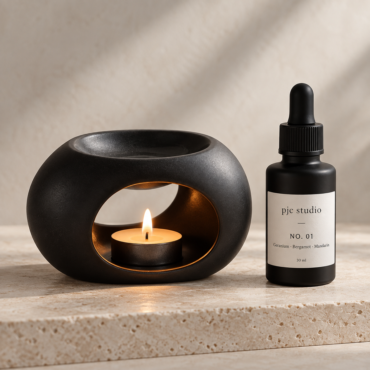 Matte black ceramic oil burner and No. 01 home fragrance oil from pjc studio