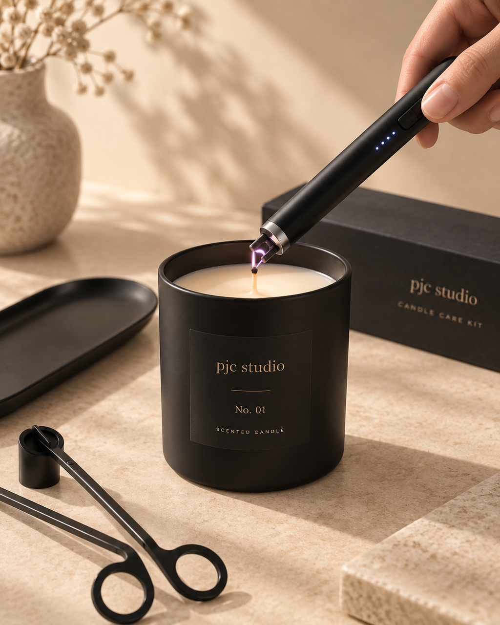 Matte black candle care tools from pjc studio, including wick trimmer, snuffer and rechargeable lighter