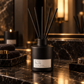 pjc studio No. 02 After Dark reed diffuser on black marble in warm evening light