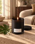 Lit pjc studio No. 03 Sunday candle with fig leaf and neroli blossoms in soft morning light